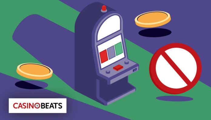 The Role of Casino Self-Exclusion Programs in Helping Problem Gamblers Illustration of a slot machine with coins floating nearby and a prohibition symbol. The Casino Beats logo is in the corner, conveying a restricted gambling theme