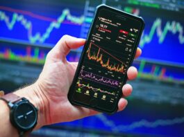 Many Americans Believe Prediction Markets are Reshaping Culture, Survey Shows Smartphone displaying market charts, reflecting growing interest in prediction markets and online betting culture