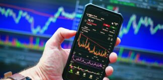 Many Americans Believe Prediction Markets are Reshaping Culture, Survey Shows Smartphone displaying market charts, reflecting growing interest in prediction markets and online betting culture