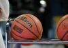 Betting Abuse Hits High-Water Mark for NCAA DI Men’s Basketball Players College basketballs resting on a rack courtside during a game
