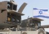 Israel Indicts Two Over Use of Military Secrets for Polymarket Bets Israeli military equipment displayed beneath an Israeli flag during a defense exercise.