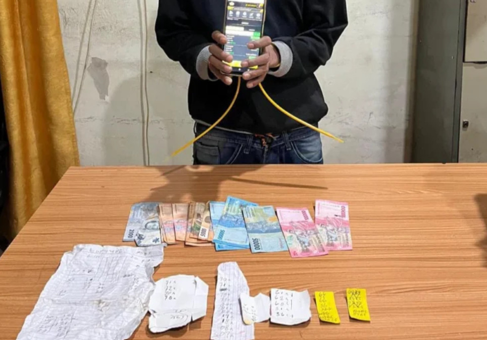 An Indonesian man charged with selling illegal lottery tickets for cash in a coffee shop.