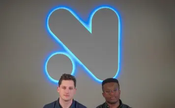 Novig Secures $75M as It Eyes Entry Into Sports Prediction Markets Novig founders seated on a couch beneath the company’s illuminated logo at the firm’s headquarters.