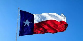 Hitchcock Mayor Arrested For Facilitating Gambling, Prostitution and Drug Trafficking The flag of Texas waving on a flagpole.