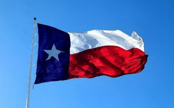 Hitchcock Mayor Arrested For Facilitating Gambling, Prostitution and Drug Trafficking The flag of Texas waving on a flagpole.
