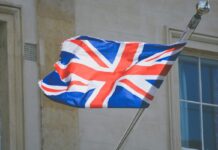 The UK flag waving on a flagpole.