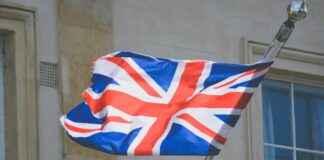The UK flag waving on a flagpole.