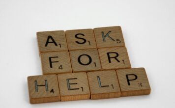 Wooden letter tiles spelling “ask for help” on a white background