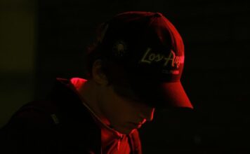 Socure Blocks 50,000 Underage Betting Accounts in One Hour During Super Bowl Teenager looking at phone