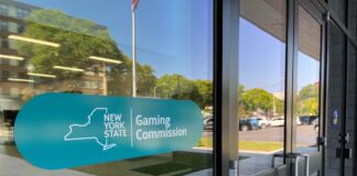 New York Gaming Commission Takes Fresh Look at Player Prop Bets Amid Integrity Concerns Entrance to the New York State Gaming Commission building with the agency’s logo displayed on the glass door.
