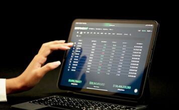 Tablet displaying live market data on a digital trading platform