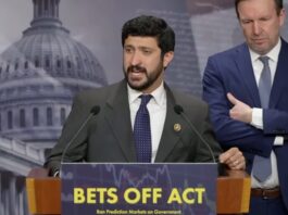 Rep. Greg Casar speaks at a podium during a press conference on the BETS OFF Act as Sen. Chris Murphy stands beside him.