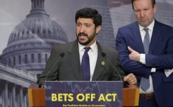 Rep. Greg Casar speaks at a podium during a press conference on the BETS OFF Act as Sen. Chris Murphy stands beside him.