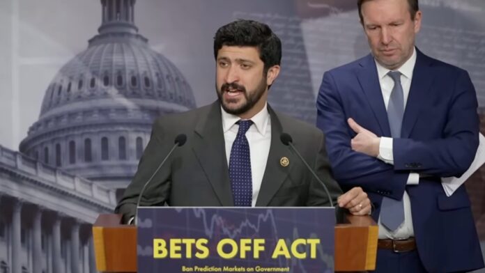 Rep. Greg Casar speaks at a podium during a press conference on the BETS OFF Act as Sen. Chris Murphy stands beside him.