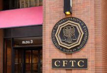 Entrance to the CFTC headquarters in Washington, D.C., with the agency’s seal and signage displayed on a brick exterior.