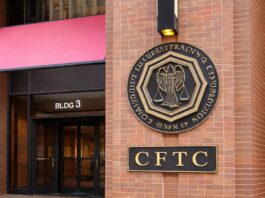 Entrance to the CFTC headquarters in Washington, D.C., with the agency’s seal and signage displayed on a brick exterior.