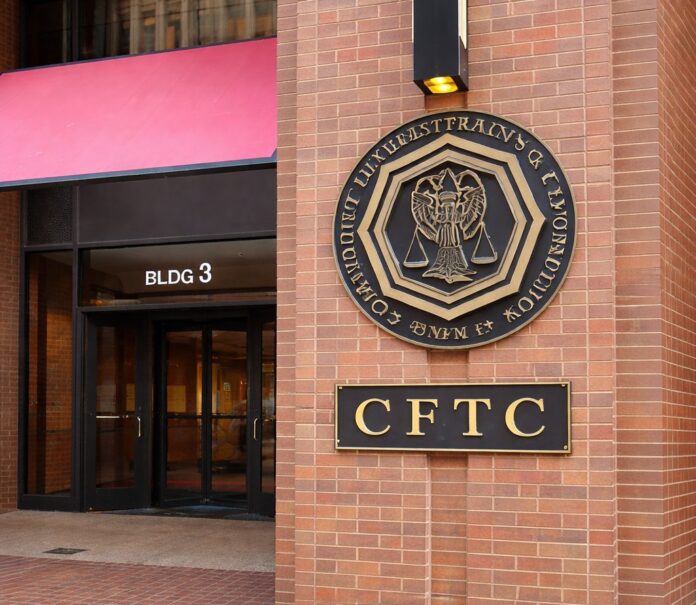 Entrance to the CFTC headquarters in Washington, D.C., with the agency’s seal and signage displayed on a brick exterior.