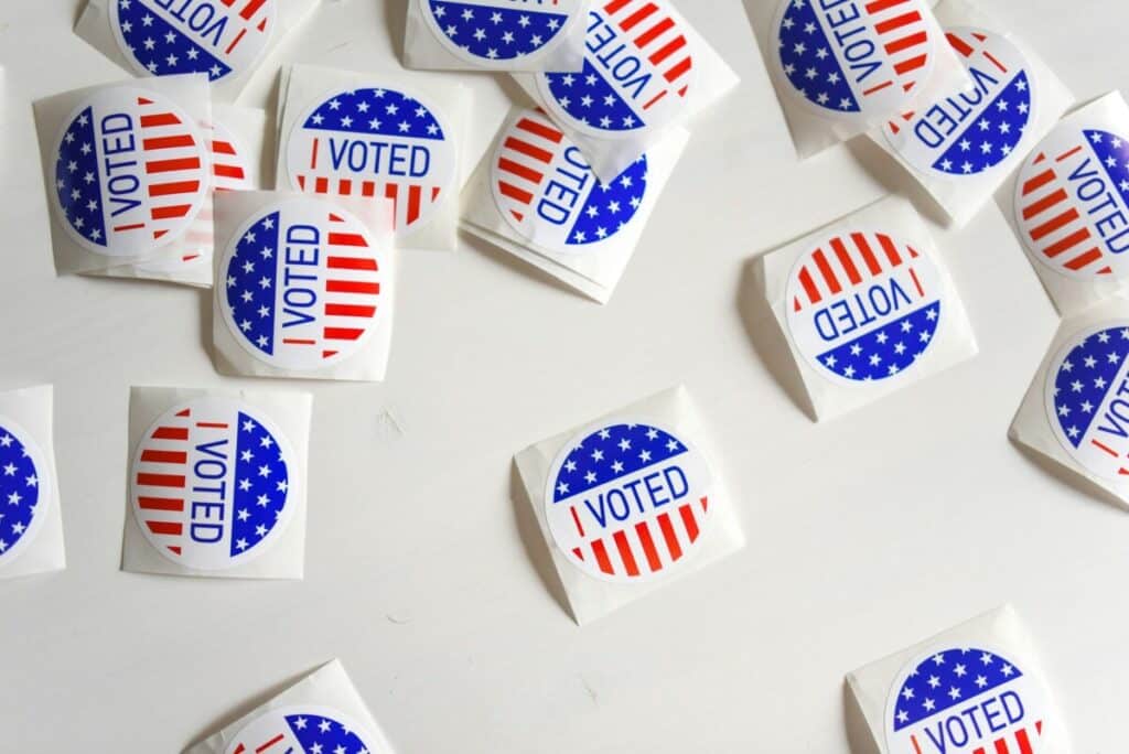 “I Voted” stickers scattered on a white surface during a U.S. election.