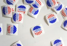 “I Voted” stickers scattered on a white surface during a U.S. election.