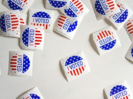 Associated Press Will Provide Election Data to Kalshi Ahead of 2026 Midterms “I Voted” stickers scattered on a white surface during a U.S. election.