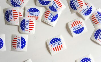 Associated Press Will Provide Election Data to Kalshi Ahead of 2026 Midterms “I Voted” stickers scattered on a white surface during a U.S. election.