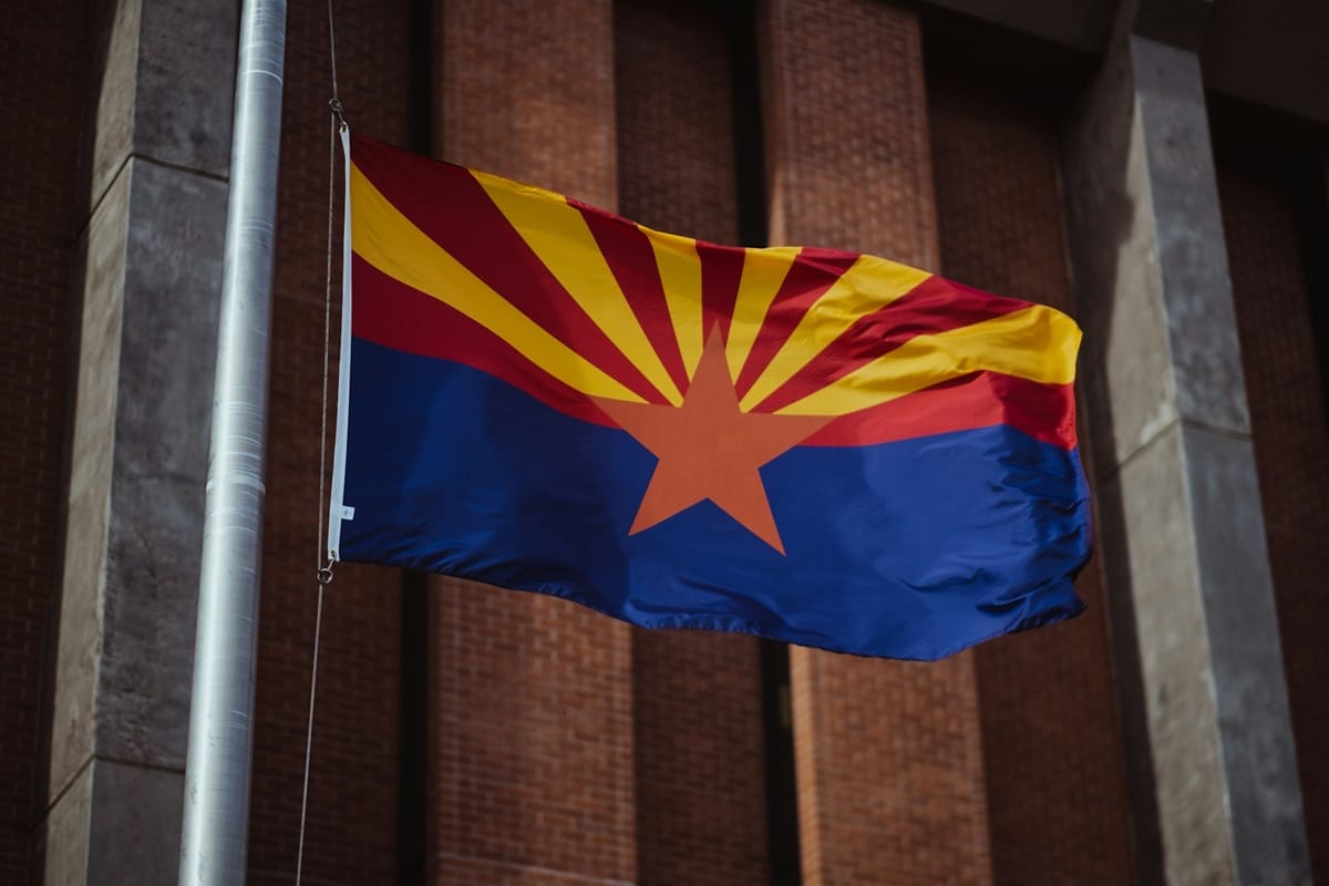 The Arizona flag flying from a flagpole.
