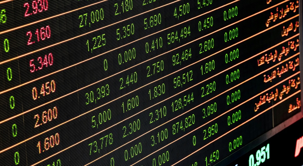 Various stock market tickers on a screen.