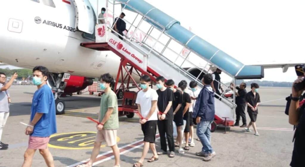 Deported Chinese nationals at an Indonesian airport en route to Guangzhou, China.
